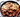 Spicy cheese buldak chicken and rice cakes topped with melted cheese and sliced green onions in a black skillet