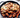 Spicy cheese buldak chicken and rice cakes topped with melted cheese and sliced green onions in a black skillet